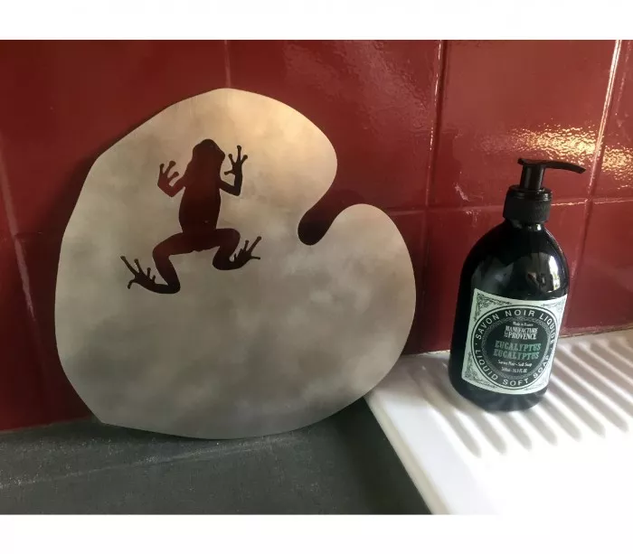 frog on water lily in brushed stainless steel trivet