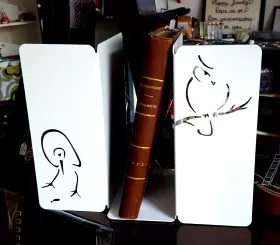 Pair of white bookends with laser cutting bird and owl