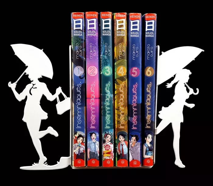 Pretty white bookends with laser-cut silhouettes of girls with umbrellas