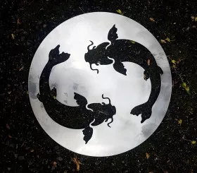 Brushed metal trivet with cut-out fish