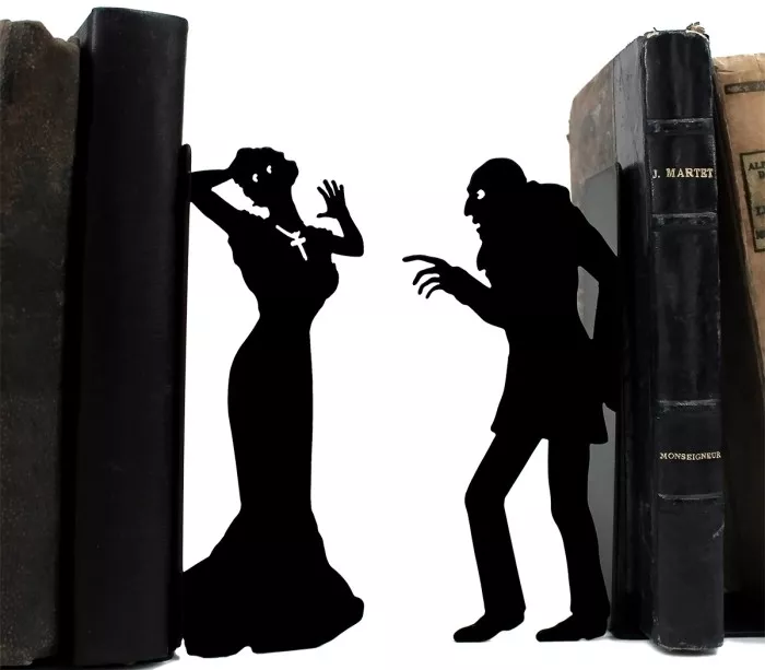 Laser-cut metal bookend with vampire and woman silhouette
